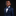 Young boy in a navy suit with a blue bow tie against a black background