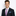 Man wearing a dark suit with a colorful striped tie and pocket square on a white background