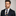 Man wearing Blue and Gold block stripe tie and accenting square