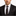 Man wearing a black suit with a patterned tie and pocket square on a white background