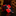 Red and black patterned tie on a reflective surface with a blurred background