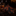 Black tie with orange floral pattern next to a glass of whiskey on a dark surface