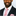 Man wearing a black suit with a pink tie and pocket square on a white background