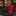 Red tie and black pocket square on a stone surface with flowers in the background