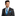 Man wearing a black suit with a blue tie and pocket square on a white background