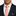 Man wearing a navy suit with a white shirt, pink polka dot tie, and matching pocket square.