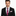 Man wearing a black suit with a pink camo tie on a white background