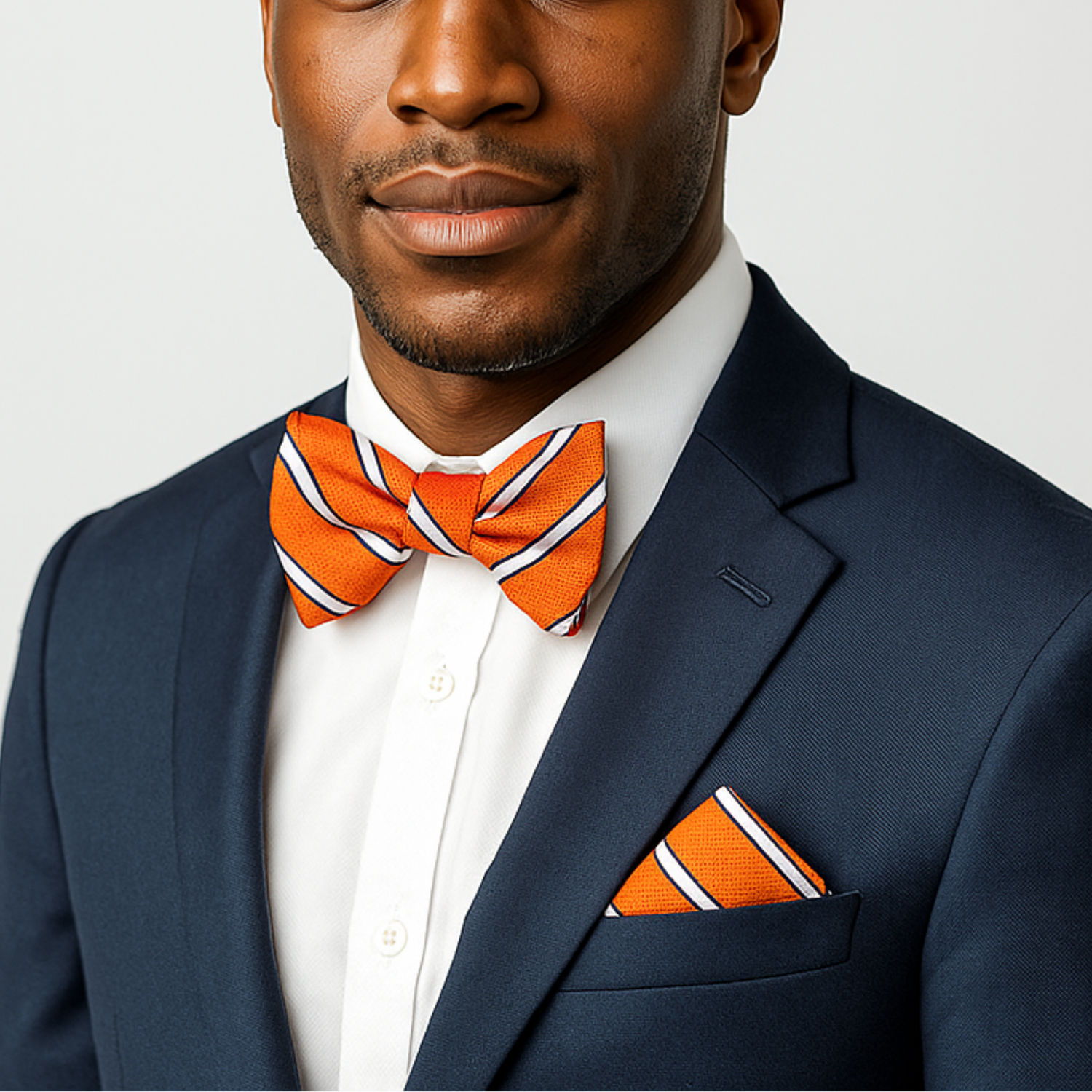 Man Wearing Orange and White Stripe Bow Tie and Square 