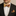 Man wearing a black suit with a red and gold bow tie and matching pocket square.