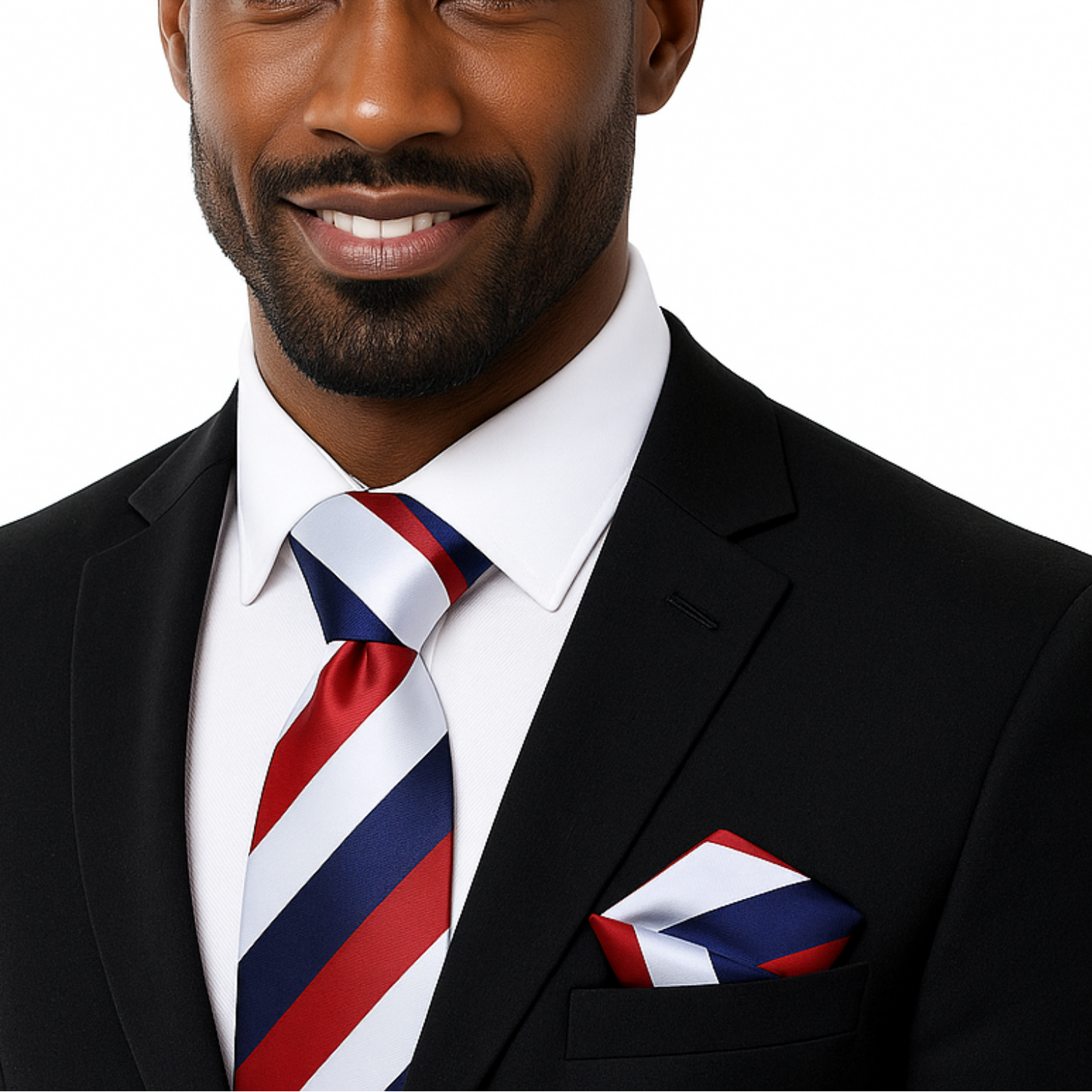 Man wearing a black suit with a red, white, and blue striped tie and pocket square on a white background