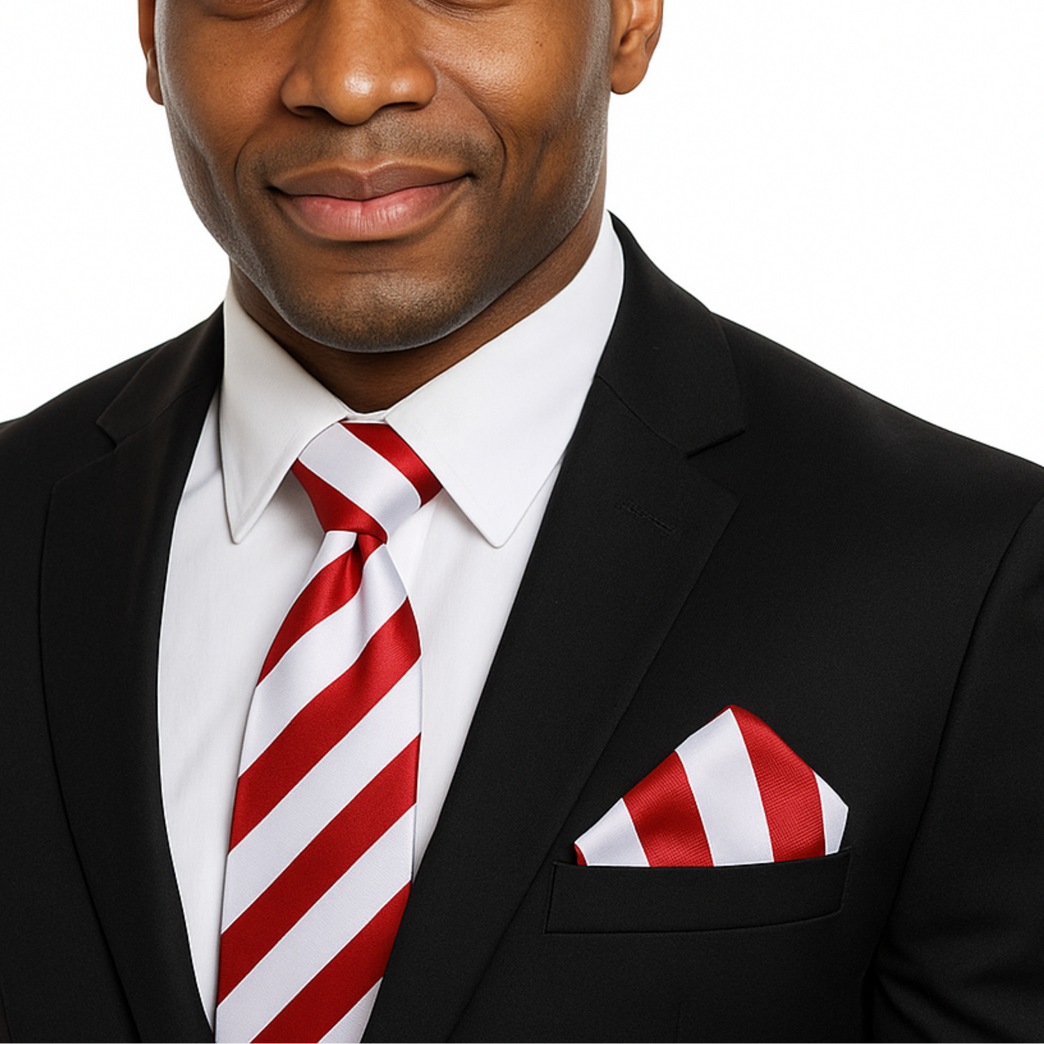 Man wearing a black suit with a red and white striped tie and pocket square on a white background