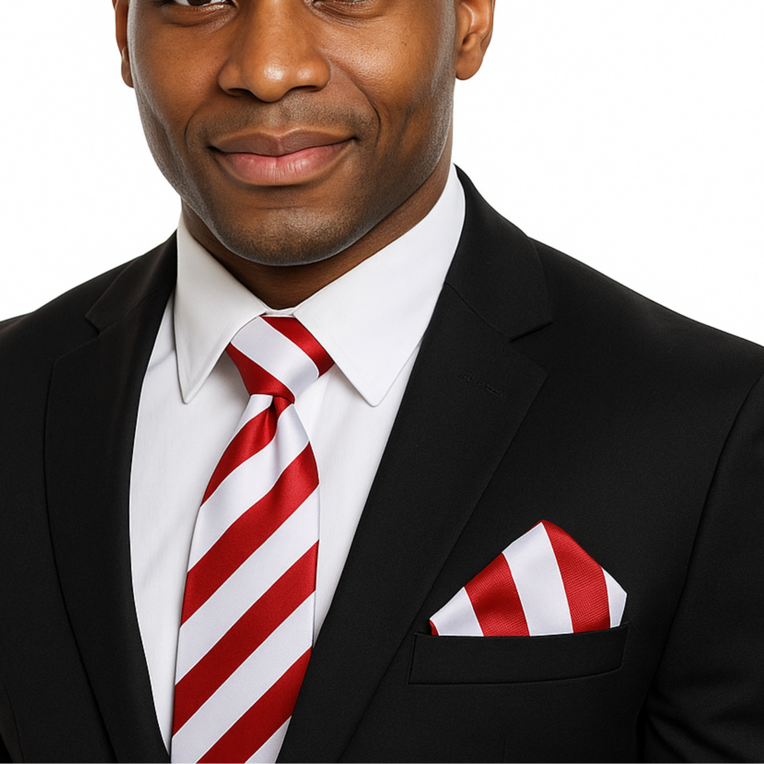 Man wearing a black suit with a red and white striped tie and pocket square on a white background