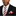 Man wearing a black suit with a red and white striped tie and pocket square on a white background