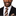 Man wearing a black suit with a brown striped tie and pocket square on a white background