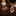 Brown Striped tie and pocket square on a dark surface with decorative items in the background