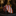 Rolled-up orange and white striped tie on a dark surface with decorative background