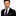 Man wearing a black suit with a blue and red striped tie and pocket square on a white background