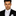Man wearing a black suit with a white shirt and tie on a white background