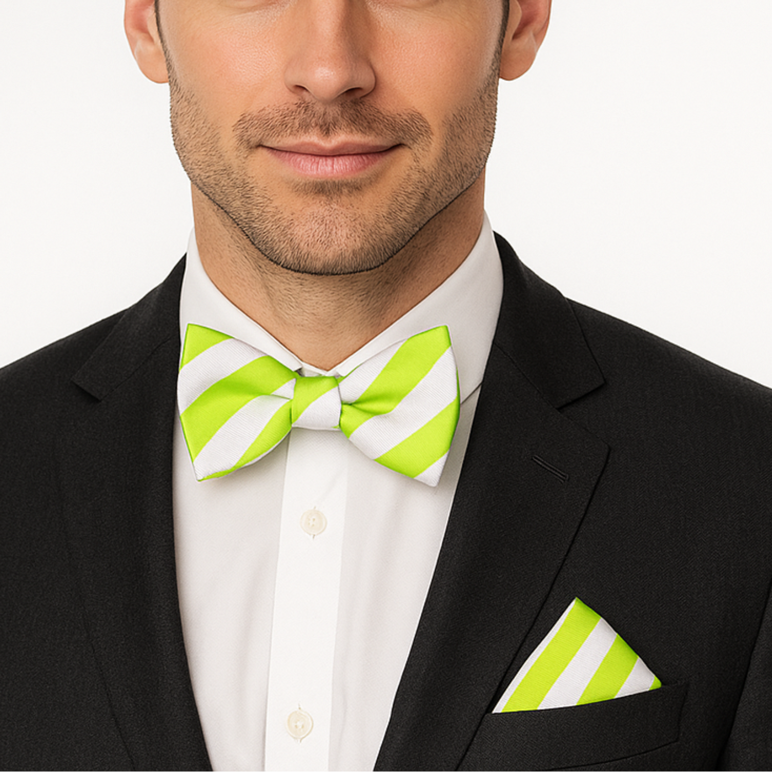 Man wearing a black suit with a white shirt, green striped bow tie, and matching pocket square on a white background.