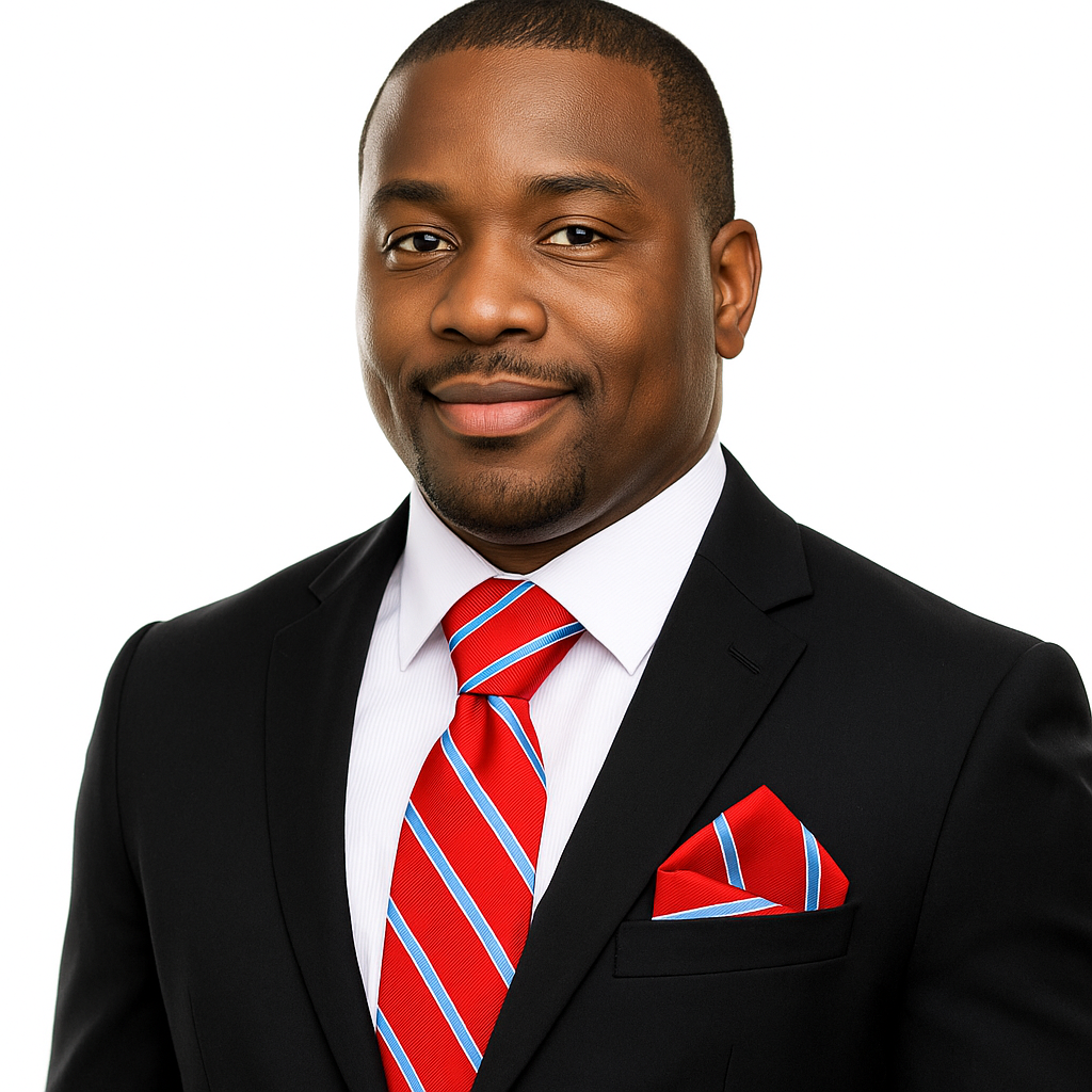 Man wearing a black suit with a red with blue stripes tie and pocket square on a white background