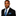 Man wearing a black suit with a blue striped tie and pocket square on a white background