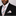 Man wearing a black suit with a striped pink and grey tie and pocket square against a plain background