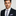 Thin colorful yellow, blue check tie and light purple shirt and light purple square on man wearing suit