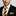 Man wearing black suit, yellow and black stripe tie and square with white background