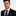 Man wearing blue and green lined necktie with matching square