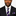 Man wearing a black suit with a purple and black tie and square