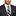 Man wearing grey suit with yellow and blue block stripe tie and square