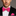 Man wearing a black suit with a pink bow tie and pocket square on a gray background