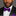 Man wearing a black suit with a purple bow tie against a gray background