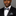 Man wearing black suit with multi colored abstract bow tie and matching square