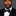 Man wearing a black suit with a black with white polka dots bow tie against a gray background