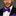 Man wearing a black suit with a purple bow tie against a gray background