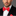 Man wearing a black suit with a A Coral Solid Pattern Self Tie Bow Tie, Matching Pocket Square against a gray background