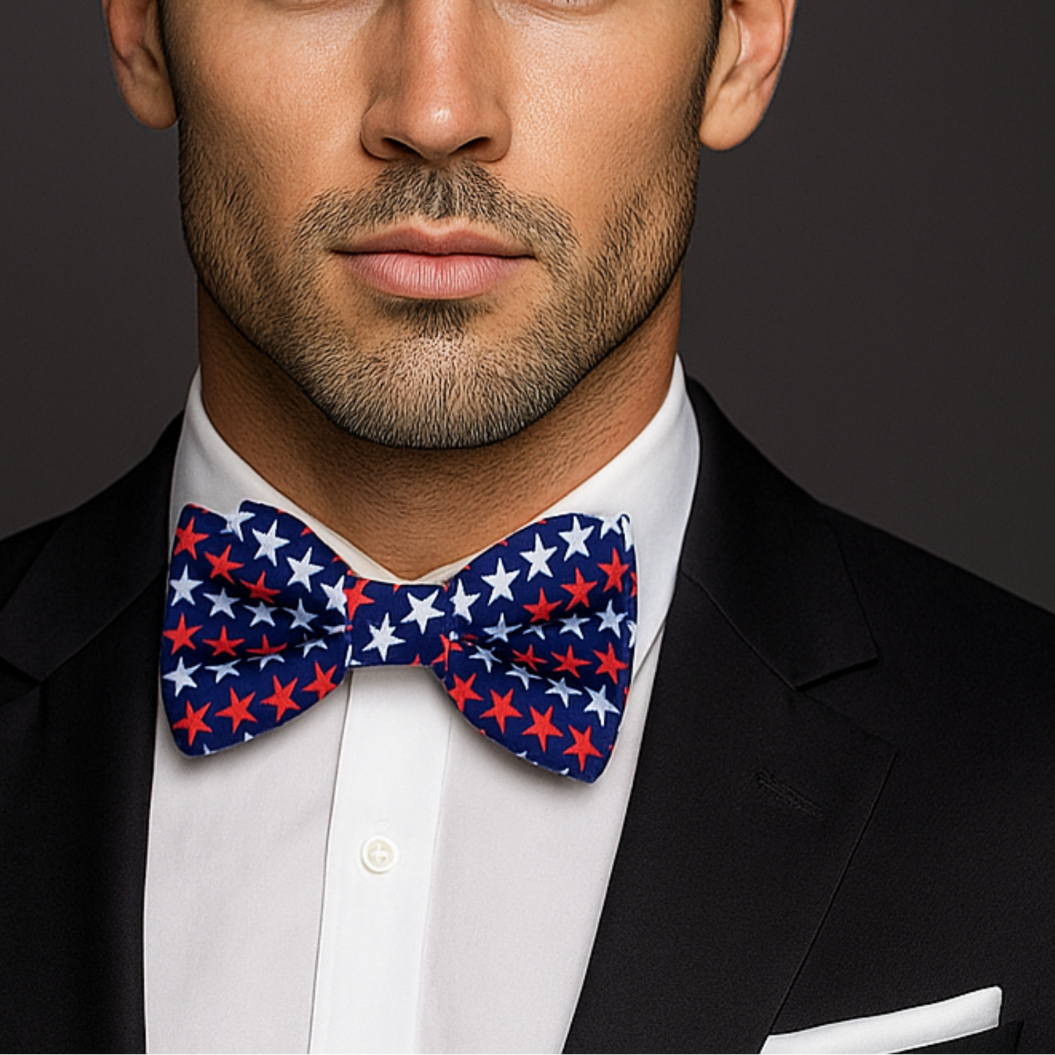 Man wearing a black suit with a Blue, Red, Blue Patriotic Stars Bow Tie and White Pocket Square