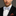Man wearing a black suit with a Light Blue, Burgundy, Cream Magnolia Flowers Bow Tie And Accenting Pocket Square