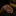Rolled Black Orange Brown Cheetah Necktie on a dark surface with blurred background