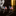American flag cufflinks on a reflective surface with a dark background