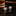 Pair of cufflinks on a reflective surface with a blurred background