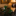 Green toy soldiers on a metallic surface with a blurred background