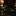Green toy soldiers with rifles on a dark surface
