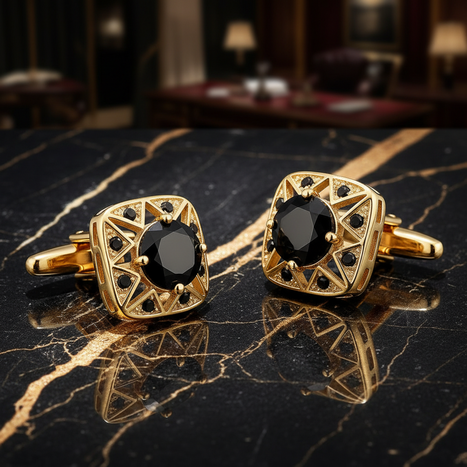 Gold cufflinks with black gemstones on a reflective black surface