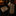 Alt View: Shades of Brown Geometric Necktie and Brown Paisley Square on a dark surface with books and a candle holder in the background.