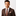 Man wearing a brown suit with a patterned tie on a white background