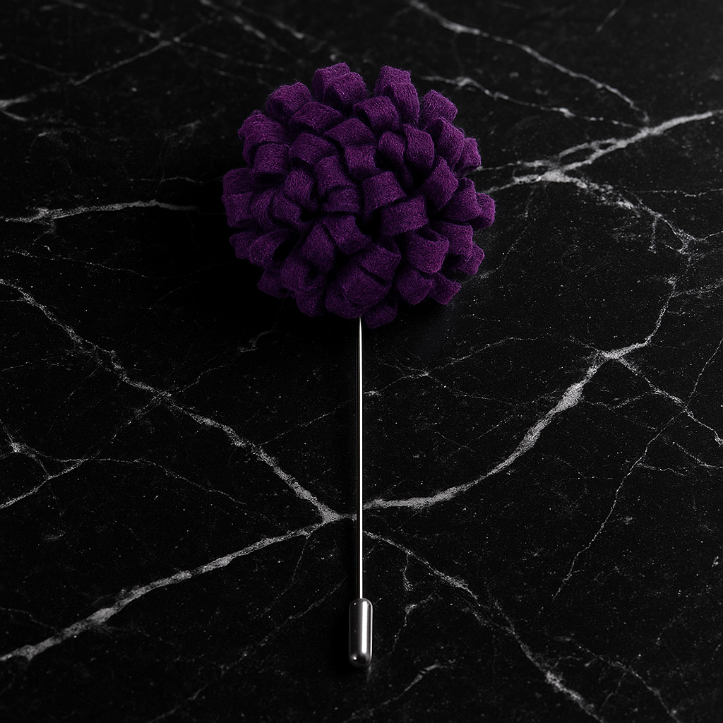 Purple flower-shaped lapel pin on a black marble surface