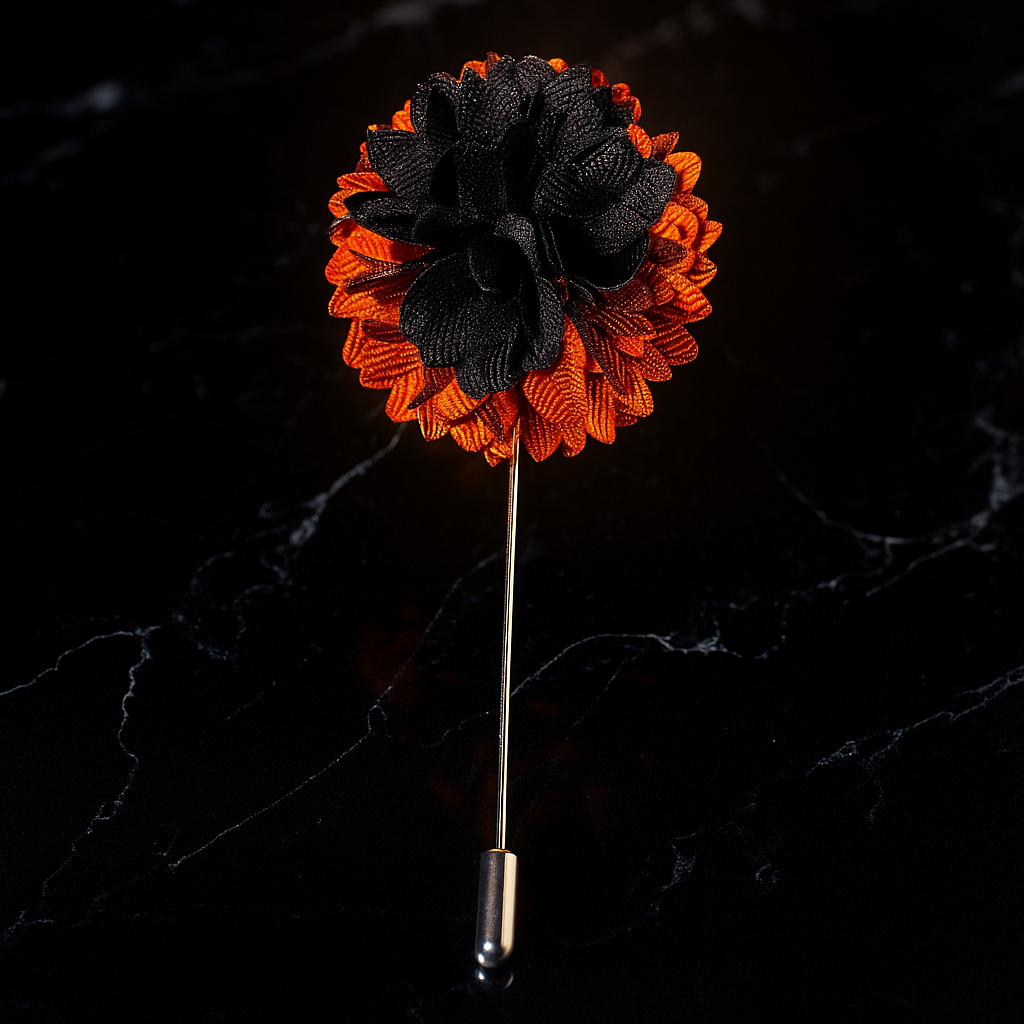 Black and orange flower lapel pin on a dark marble background