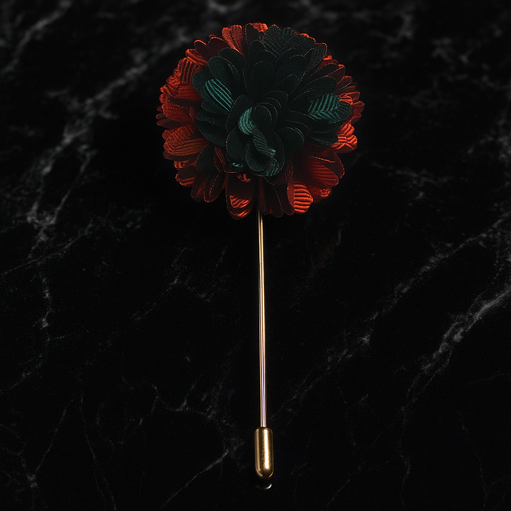 Floral lapel pin with red and green colors on a black marble background